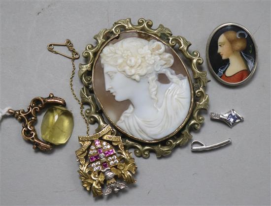 A cameo brooch, a fob, a silver brooch and two 9ct white gold pendants.